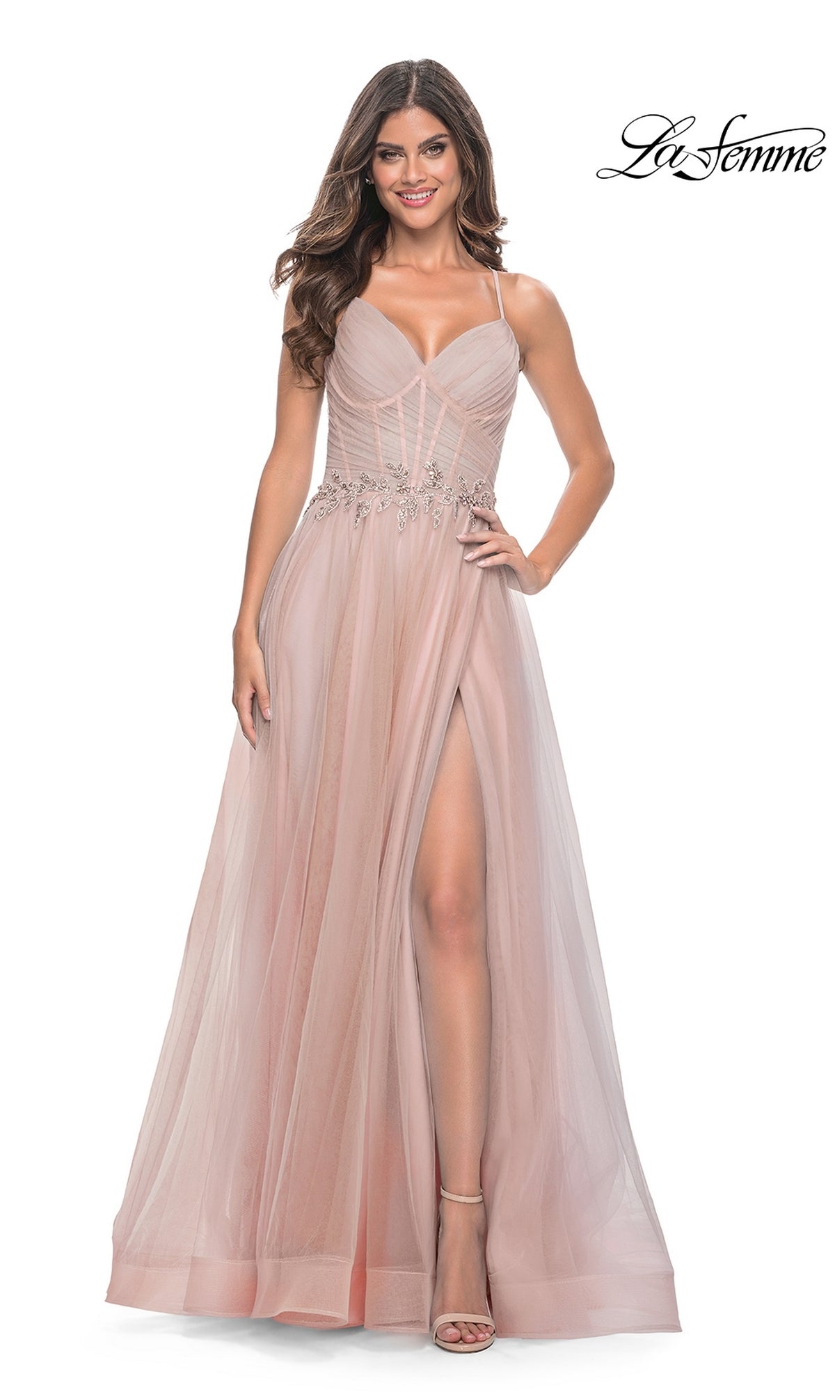Smiling woman in La Femme Sheer-Bodice Long A-Line Prom Dress 32117, blush pink with thin straps, fitted bodice, beaded waist detail, high slit, and strappy open back.